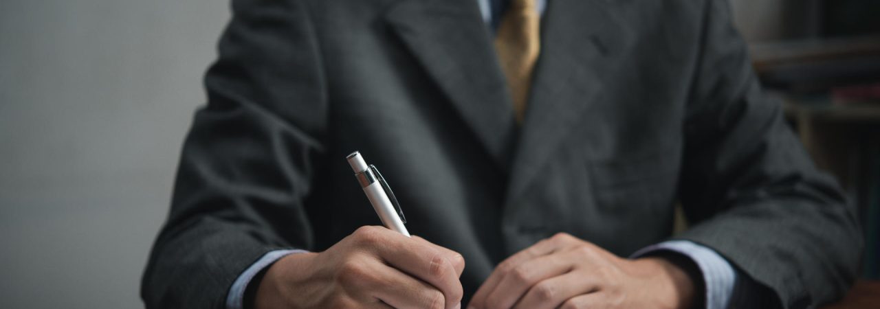 Businessman signing a contract for buying of selling a car.Car rental service. insurance, and contract agreement concepts