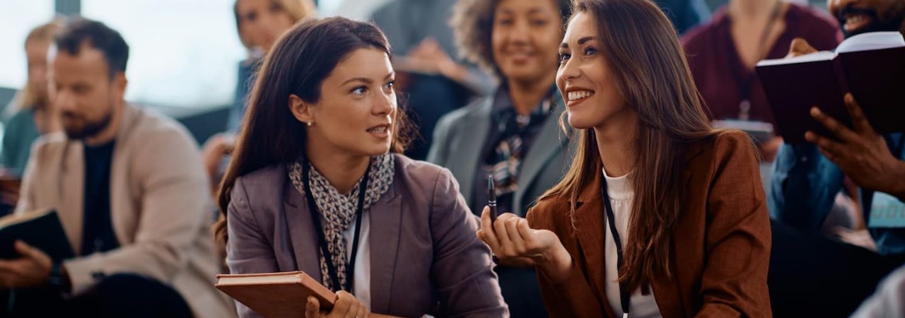 happy-female-entrepreneurs-talking-while-attending-SGHLZGL